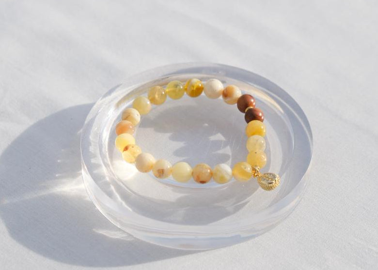 Beaded bracelet on a clear stand against a white background