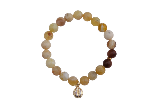 Beaded bracelet with a diamond charm on a white background