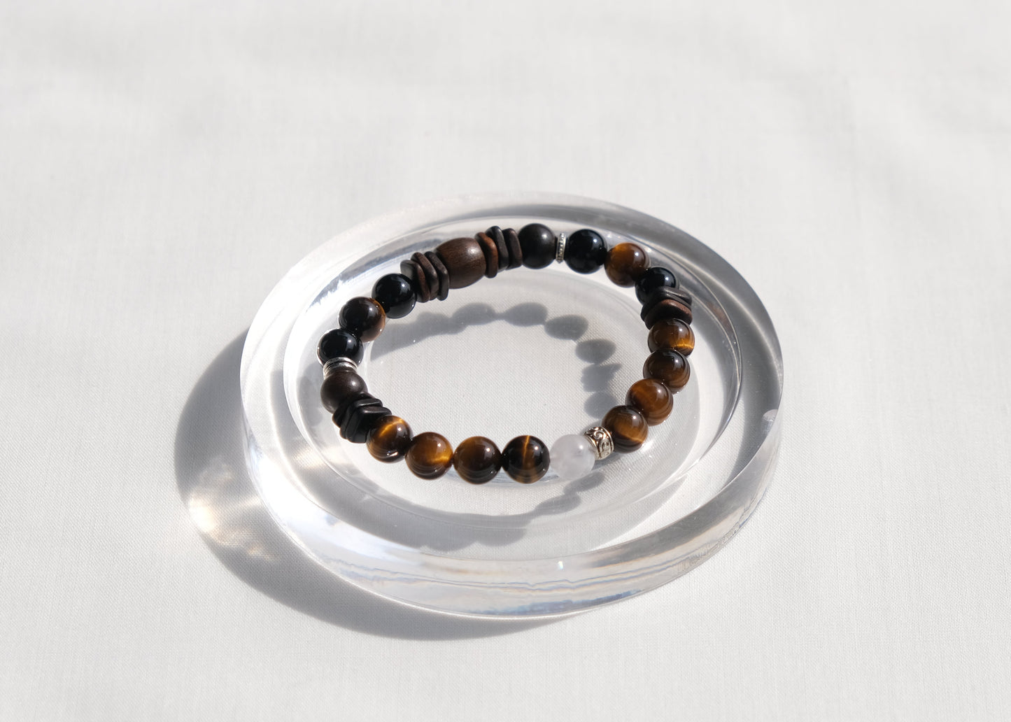 Beaded bracelet on a clear stand against a white background