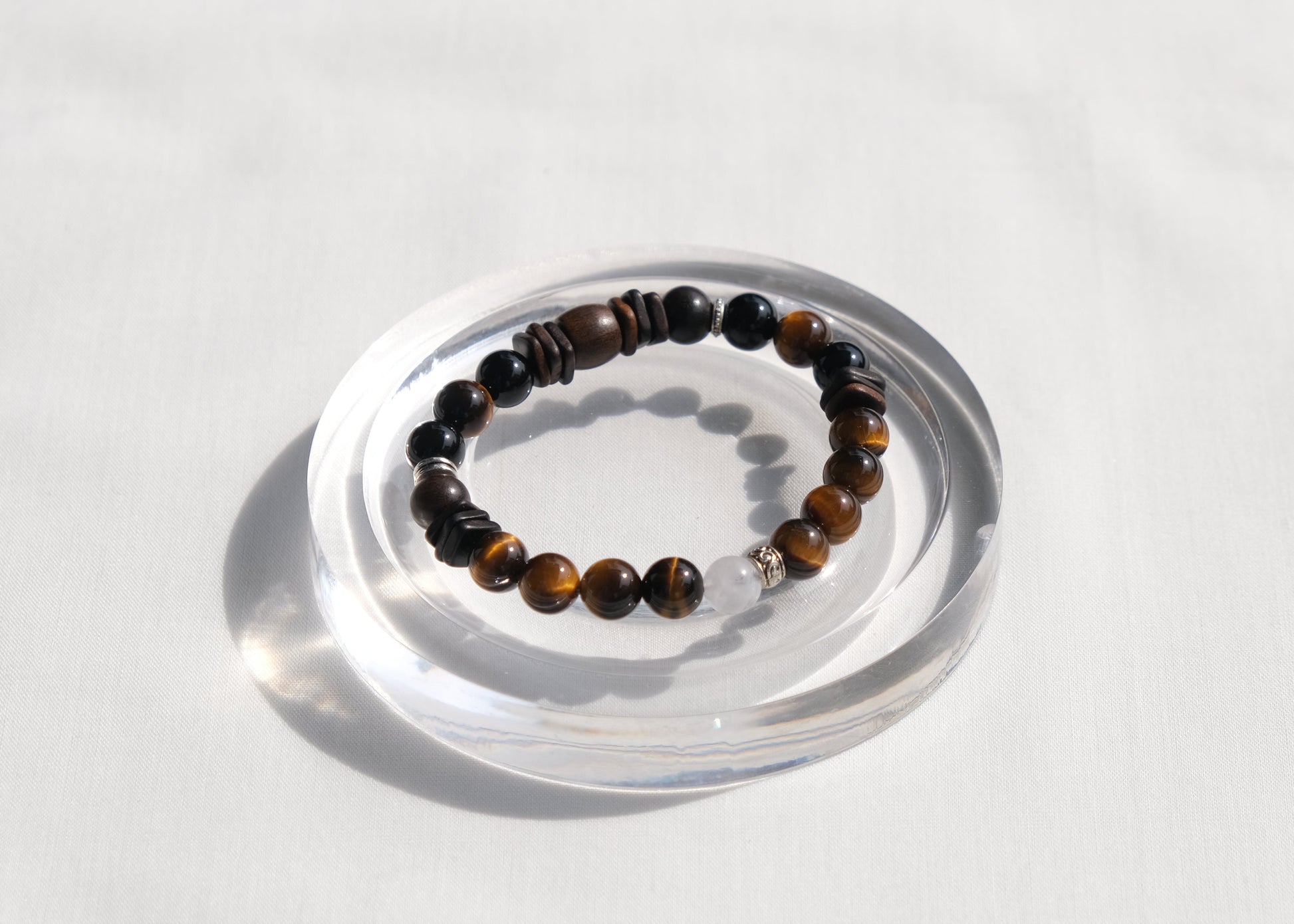Beaded bracelet on a clear stand against a white background