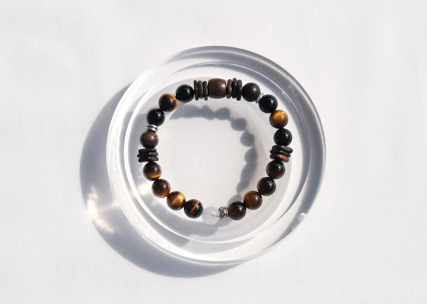 Beaded bracelet on a clear stand against a white background