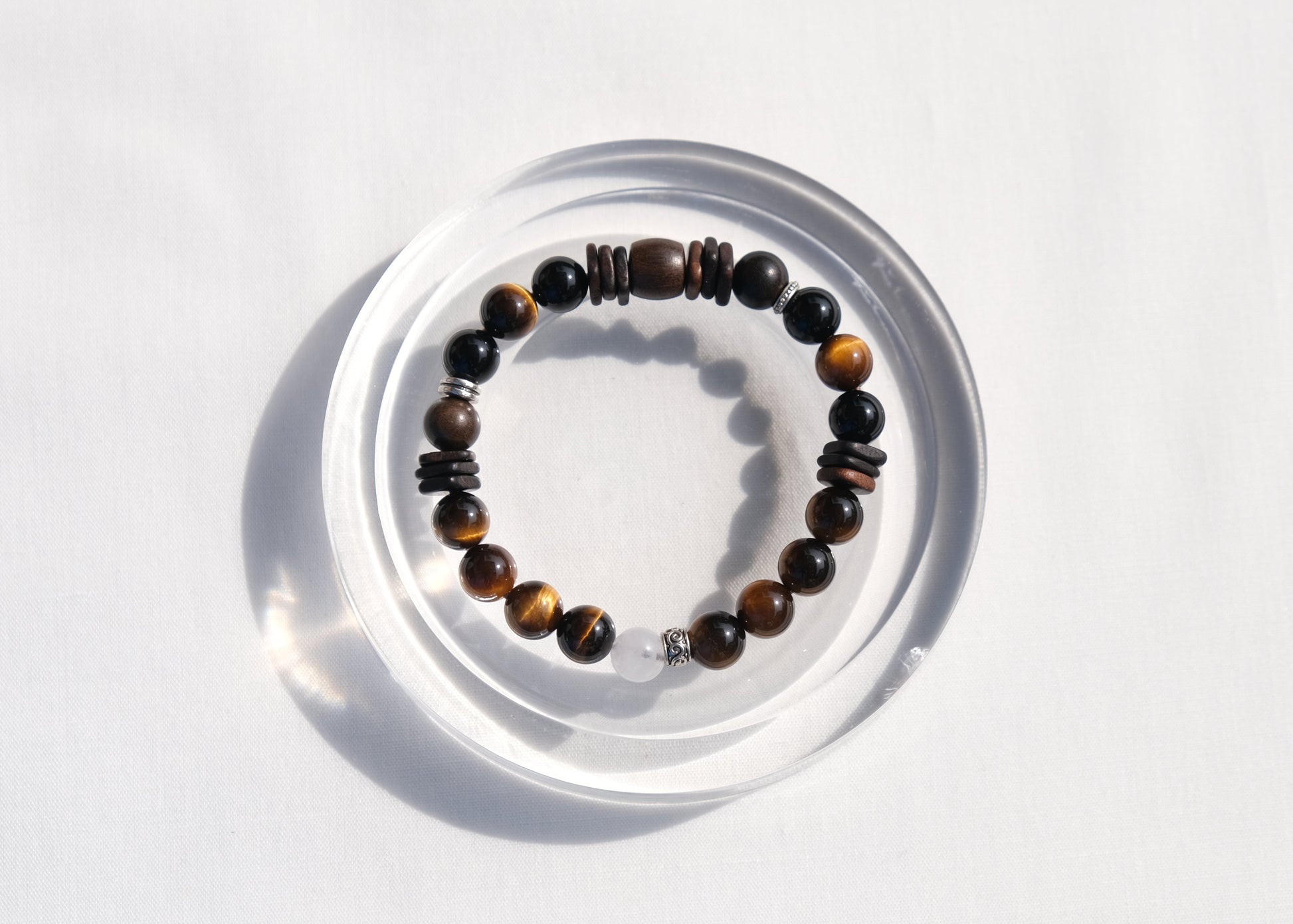 Beaded bracelet on a clear stand against a white background
