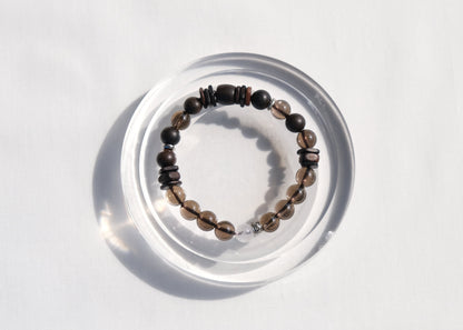 Beaded bracelet on a clear circular stand against a white background