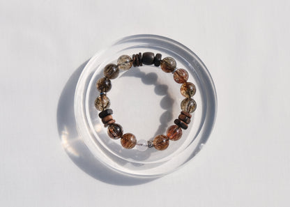 Beaded bracelet on a clear stand against a light gray background