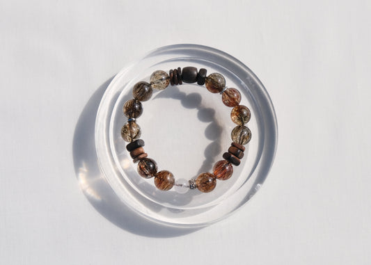 Beaded bracelet on a clear stand against a light gray background