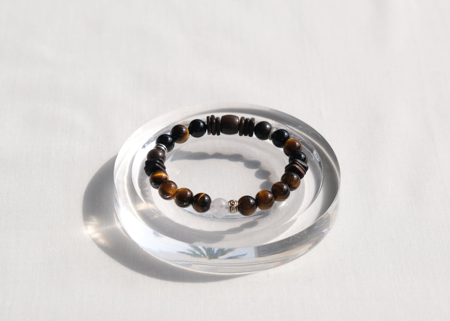 Beaded bracelet on a clear stand with a white background