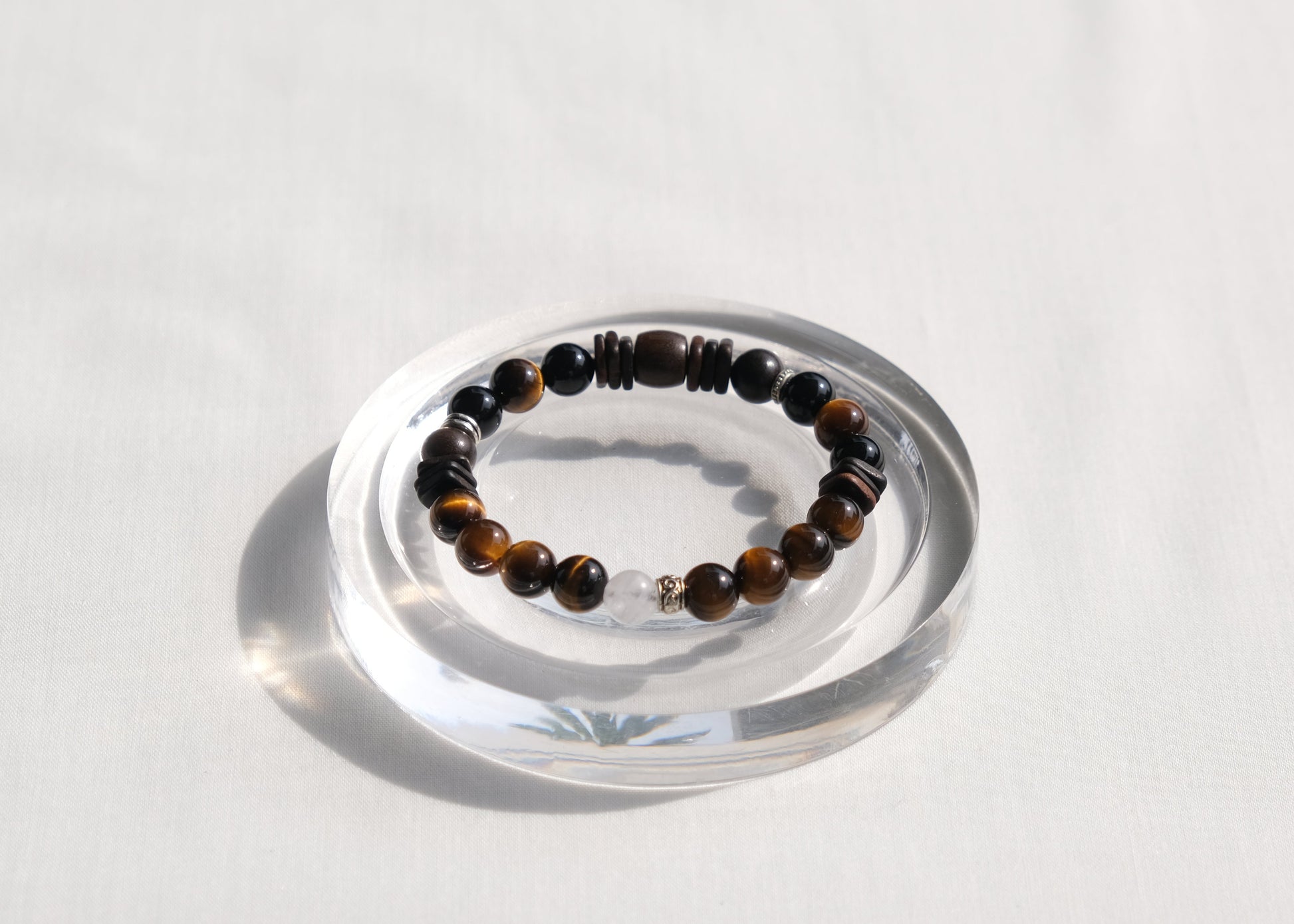 Beaded bracelet on a clear stand with a white background