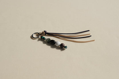 Beaded keychain with tassels on a beige background
