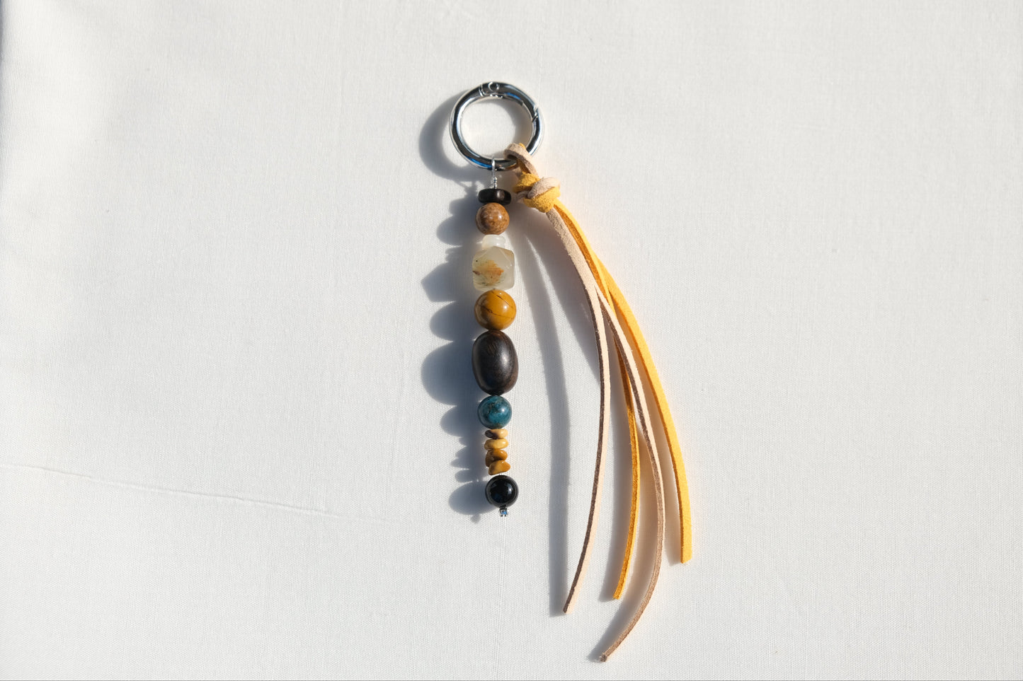 Keychain with beads and fabric strips on a white background