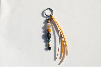 Keychain with beads and fabric strips on a white background