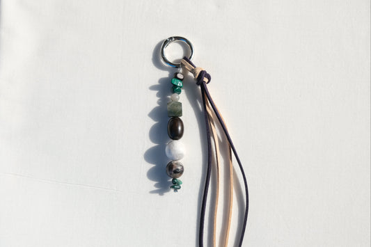 Necklace with beads and a tassel on a white background