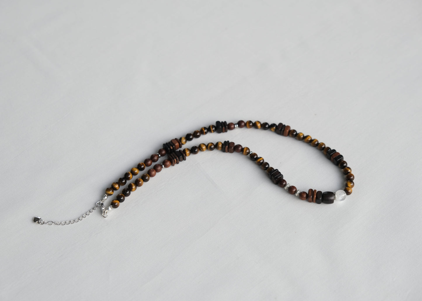 Necklace with tiger eye beads on a light gray background