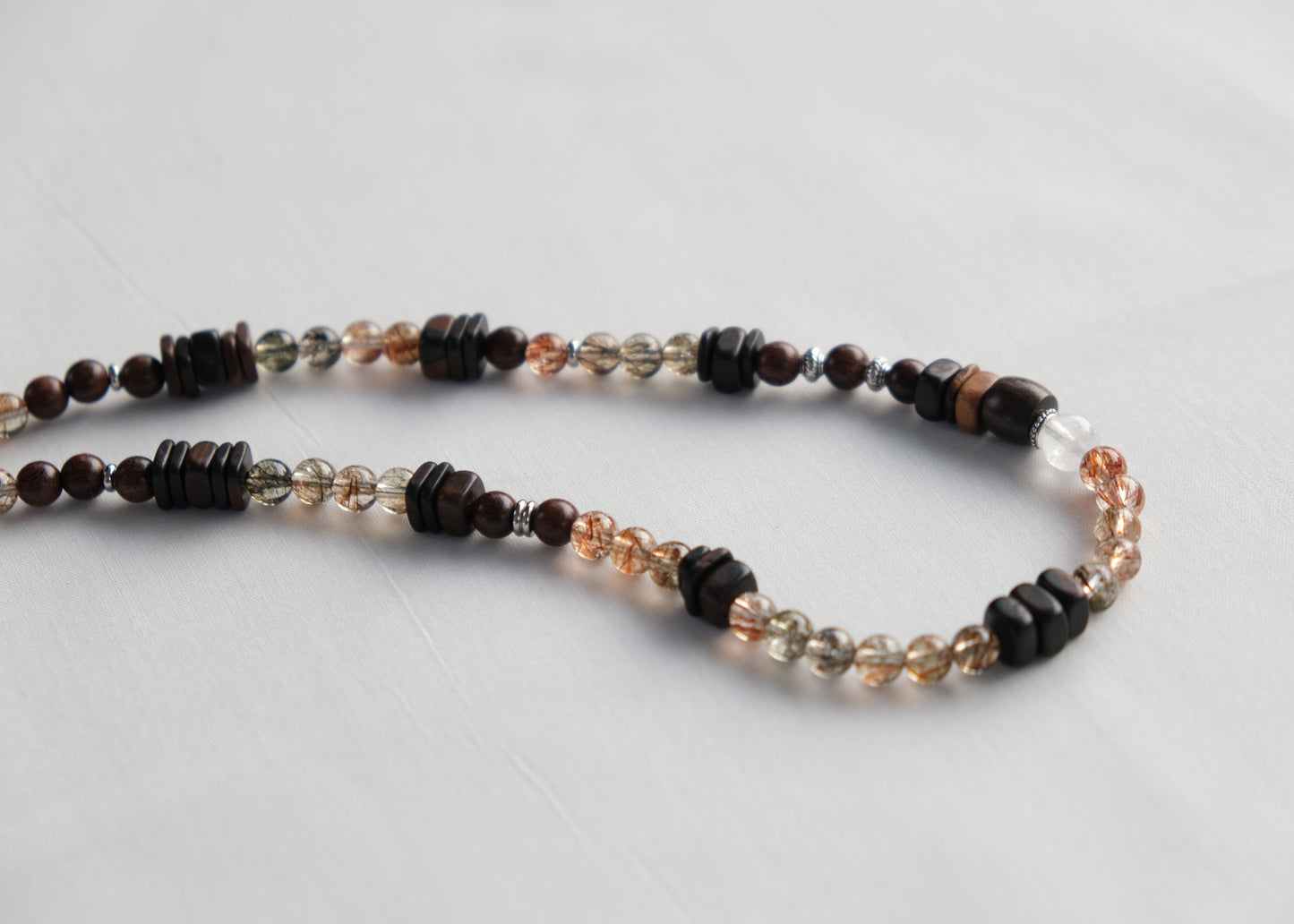 Necklace with multicolored beads on a light gray background