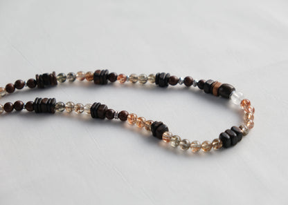 Necklace with multicolored beads on a light gray background