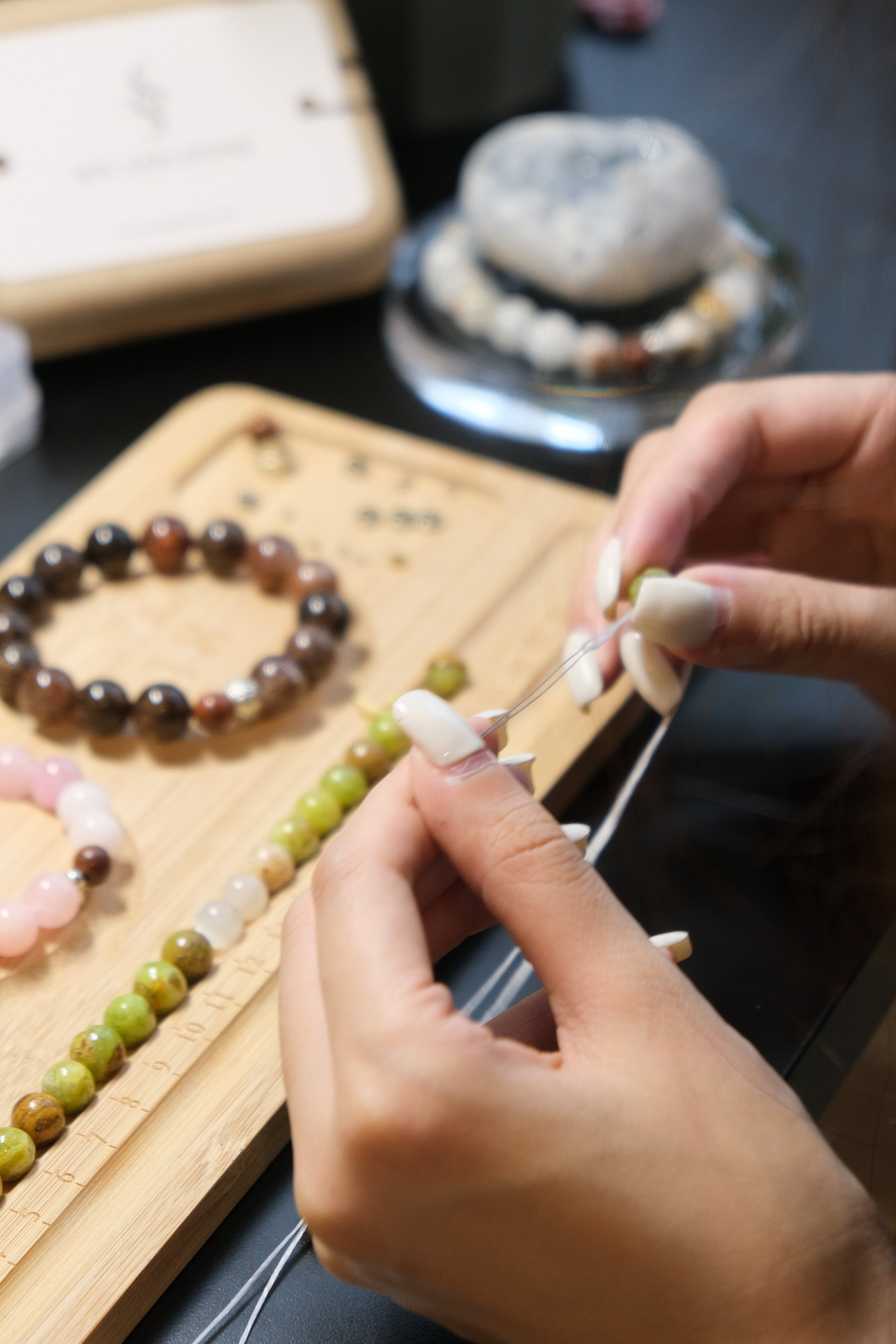 Person working with beads on a wooden board