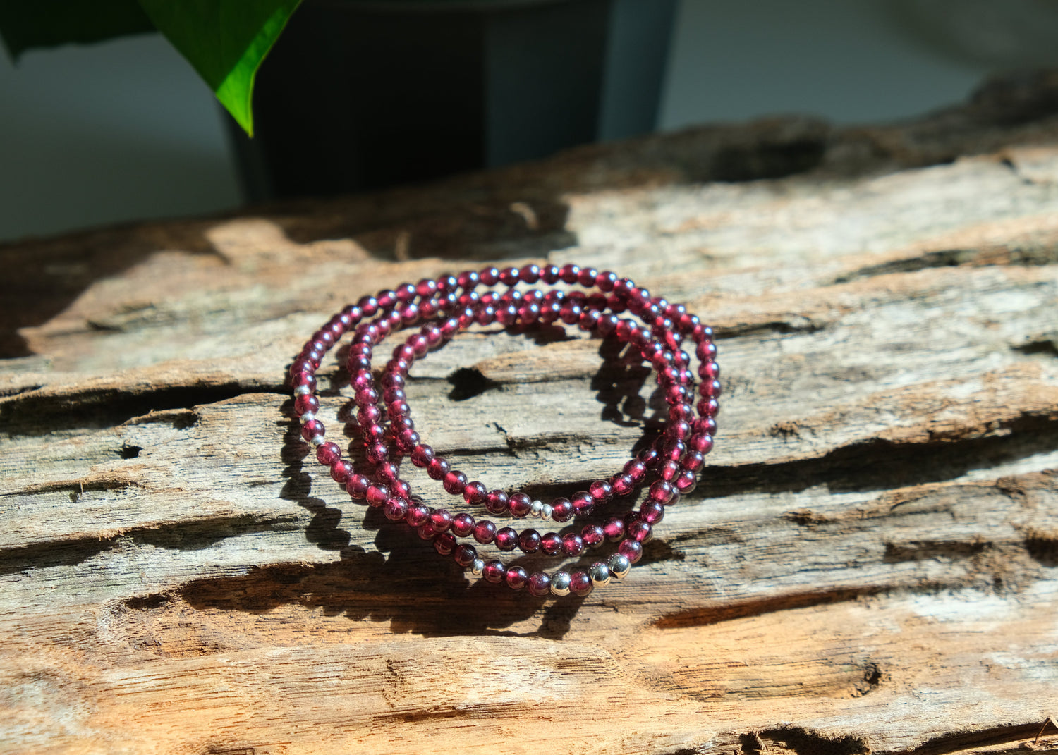 Stack of beaded bracelets on a wooden surface