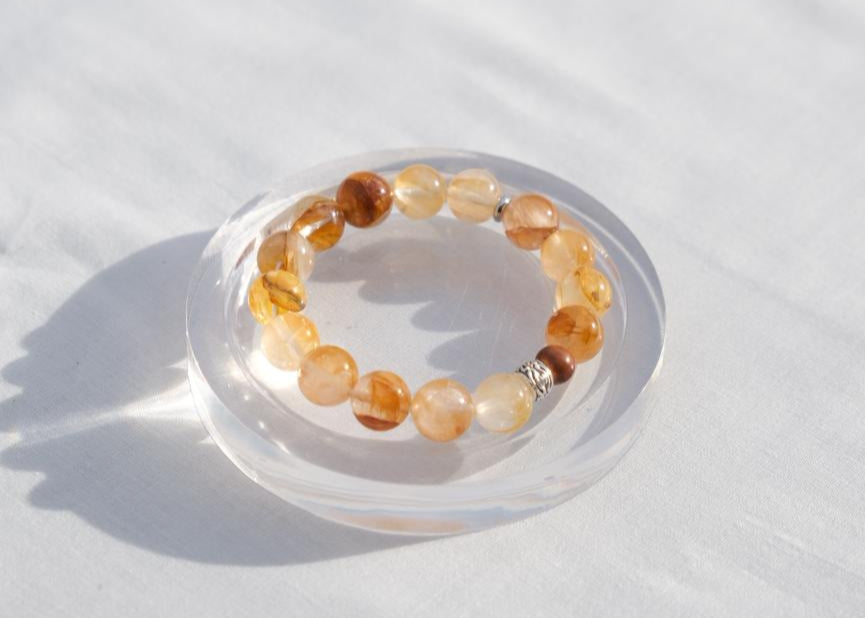 Beaded bracelet on a clear stand with a white background