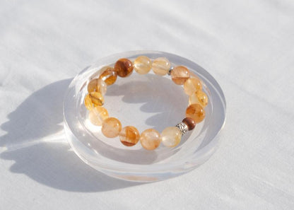 Beaded bracelet on a clear stand with a white background