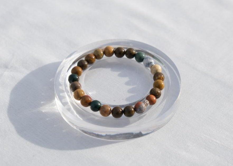 Beaded bracelet on a clear stand against a white background