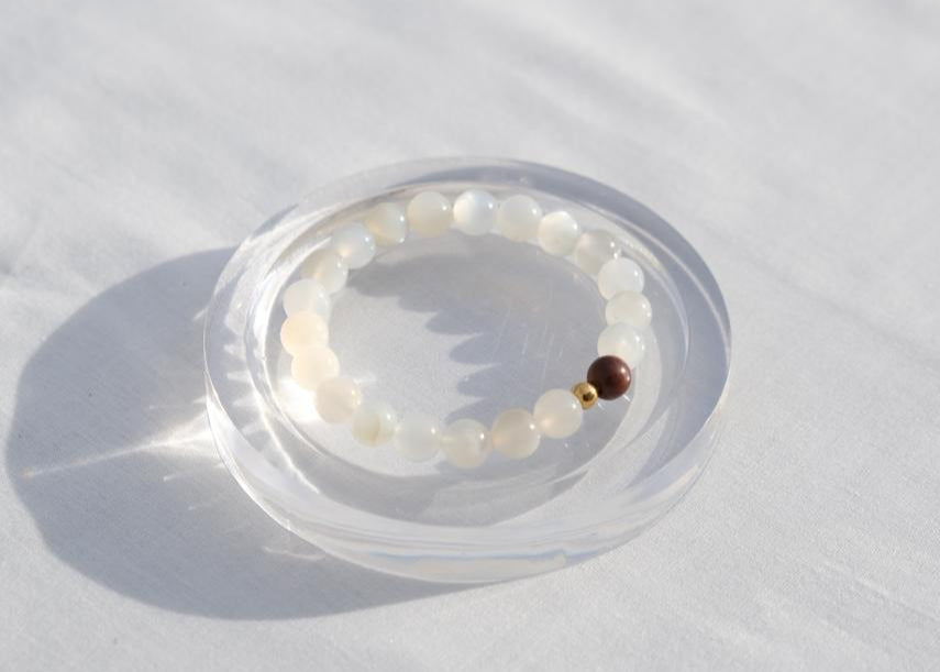 Beaded bracelet with a clear plastic case on a white background
