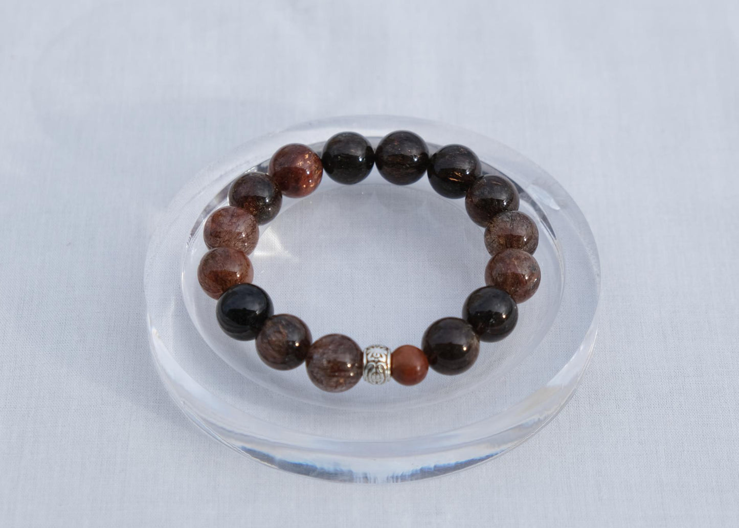 Beaded bracelet on a clear stand with a white background