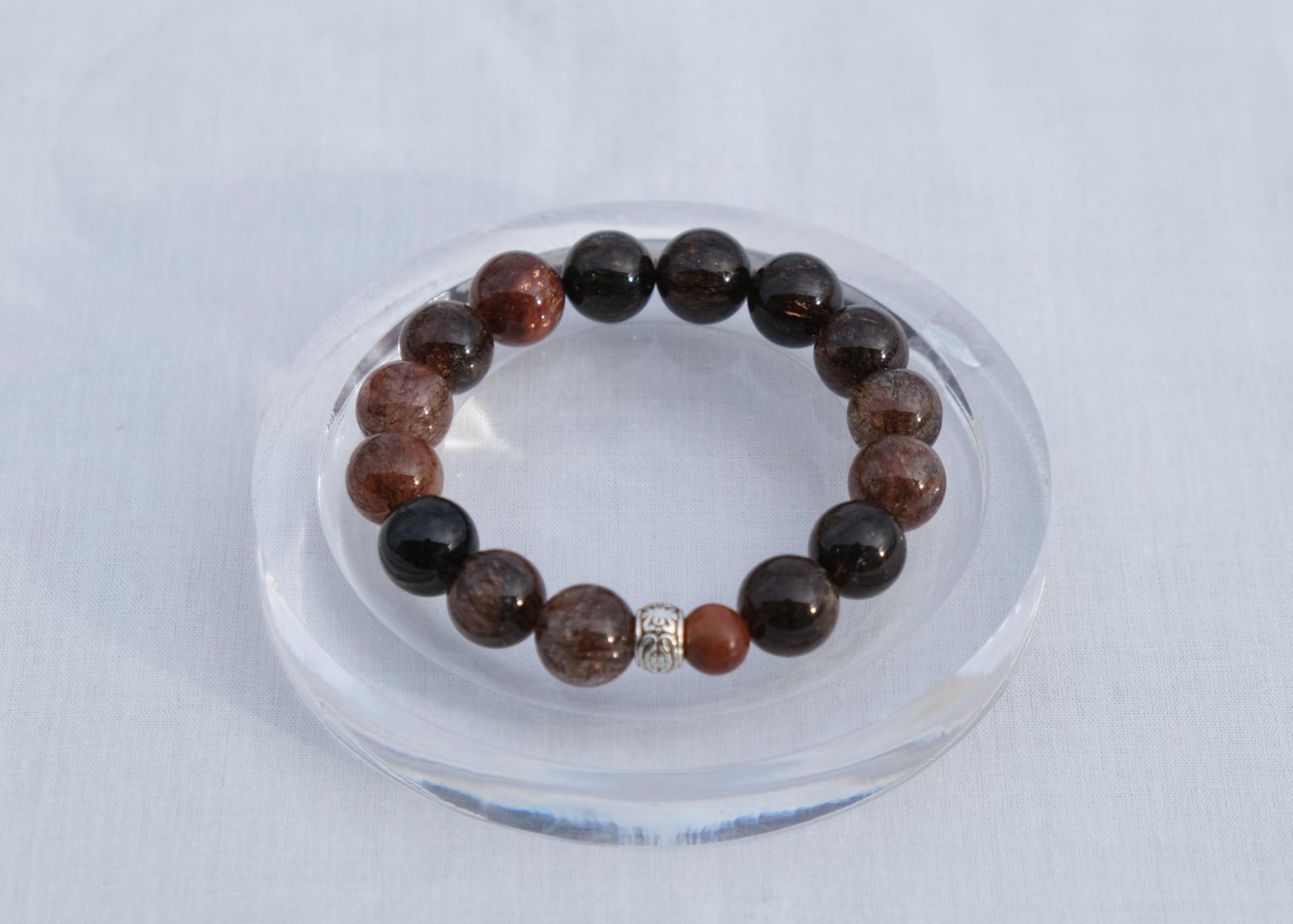 Beaded bracelet on a clear stand with a white background