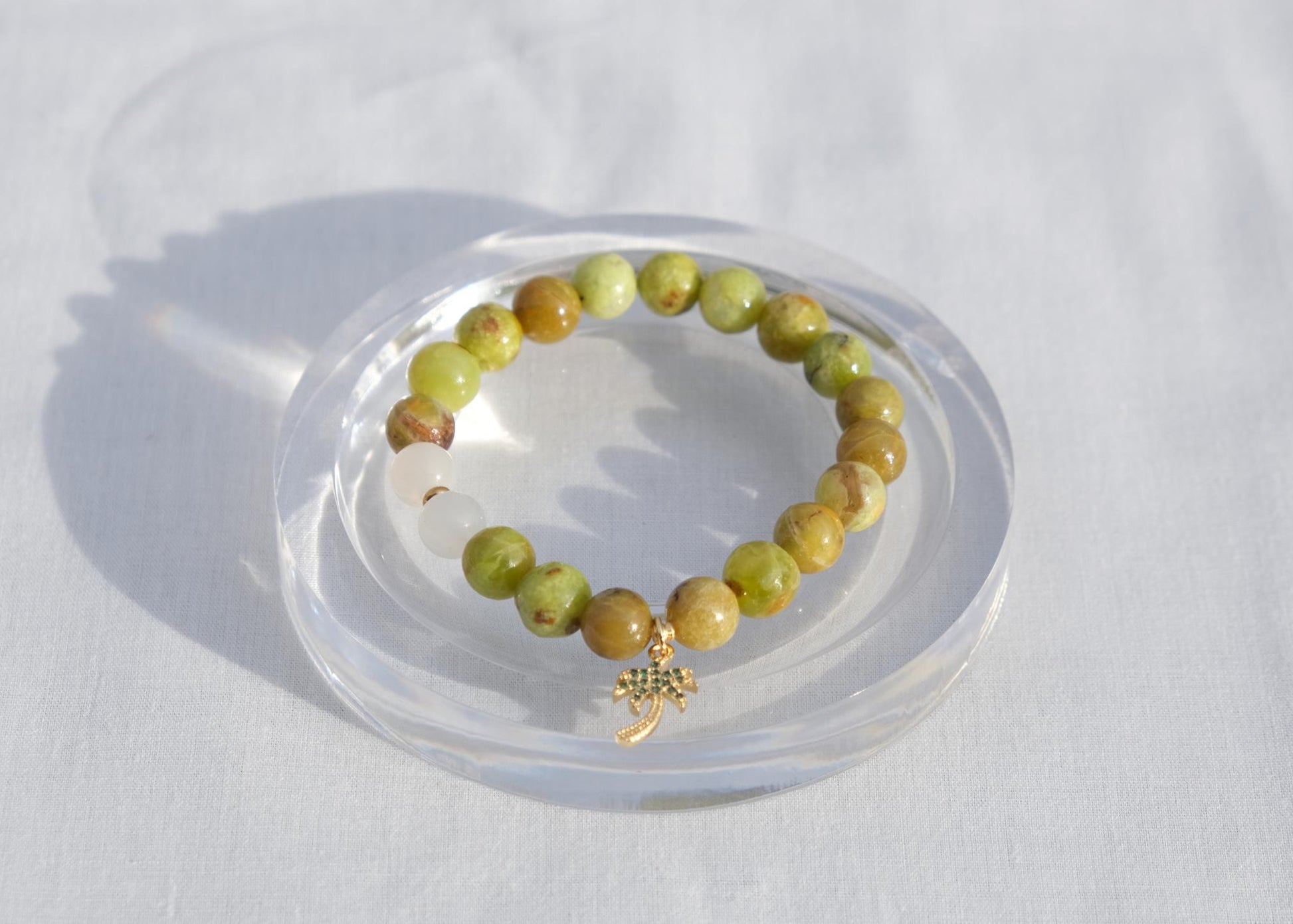 Beaded bracelet on a clear stand against a white background