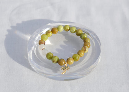 Beaded bracelet on a clear stand against a white background