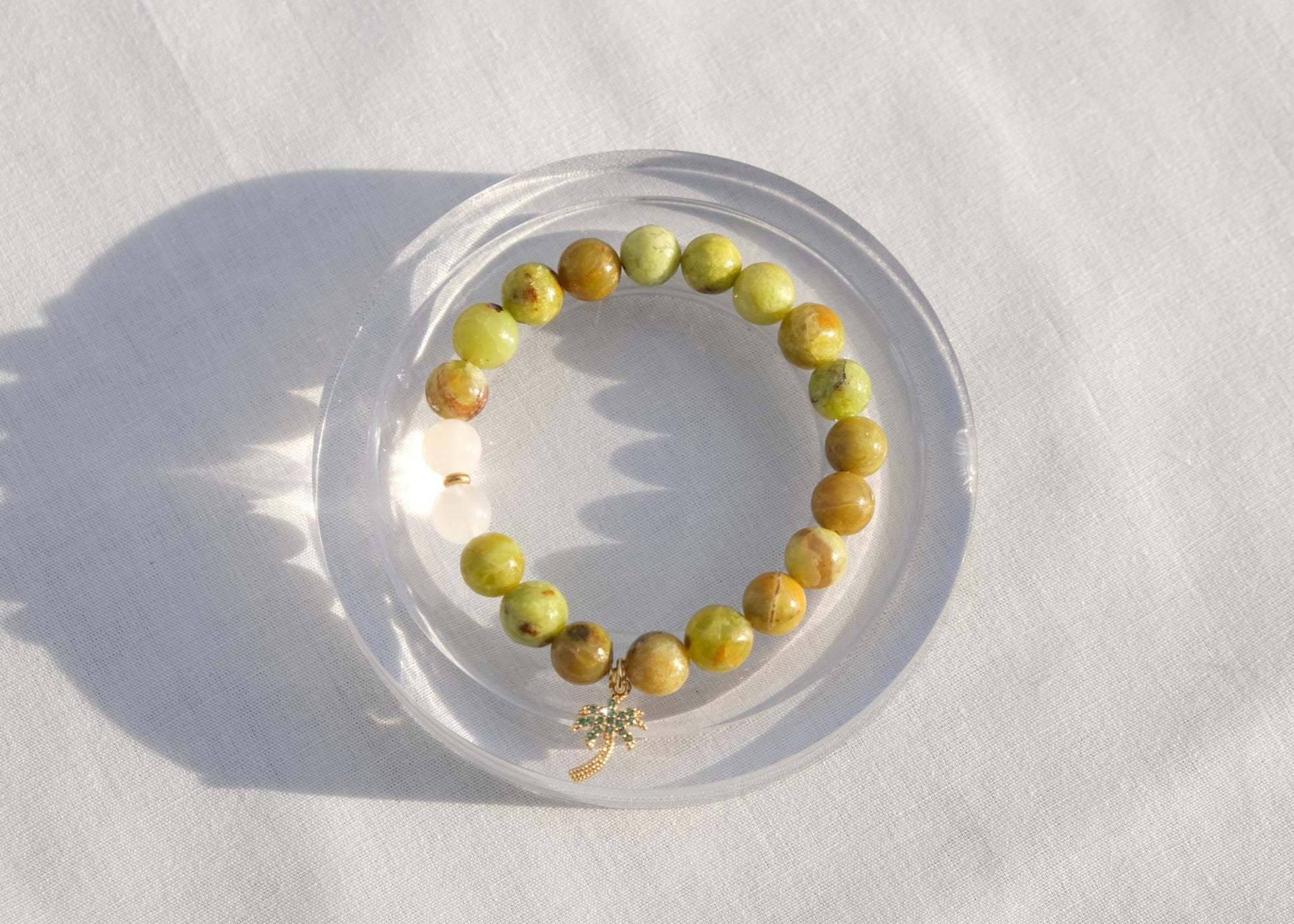 Beaded bracelet on a clear stand with a white background