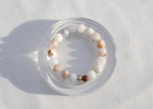 Beaded bracelet on a white surface with a soft shadow