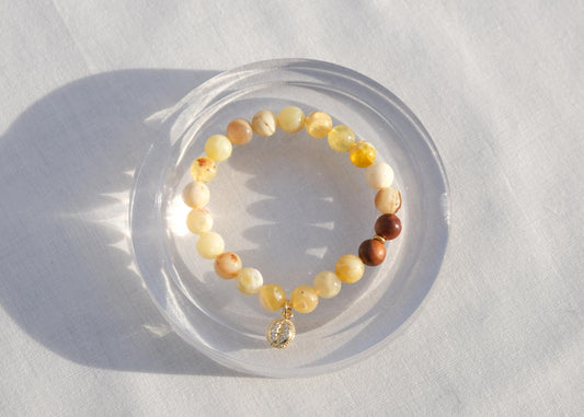 Beaded bracelet on a white surface with soft shadows