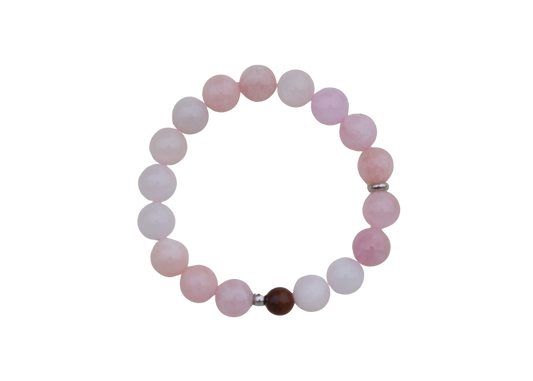 Beaded bracelet with pink and white beads on a white background