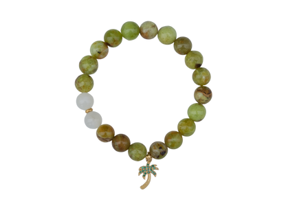 Beaded bracelet with a green leaf charm on a white background
